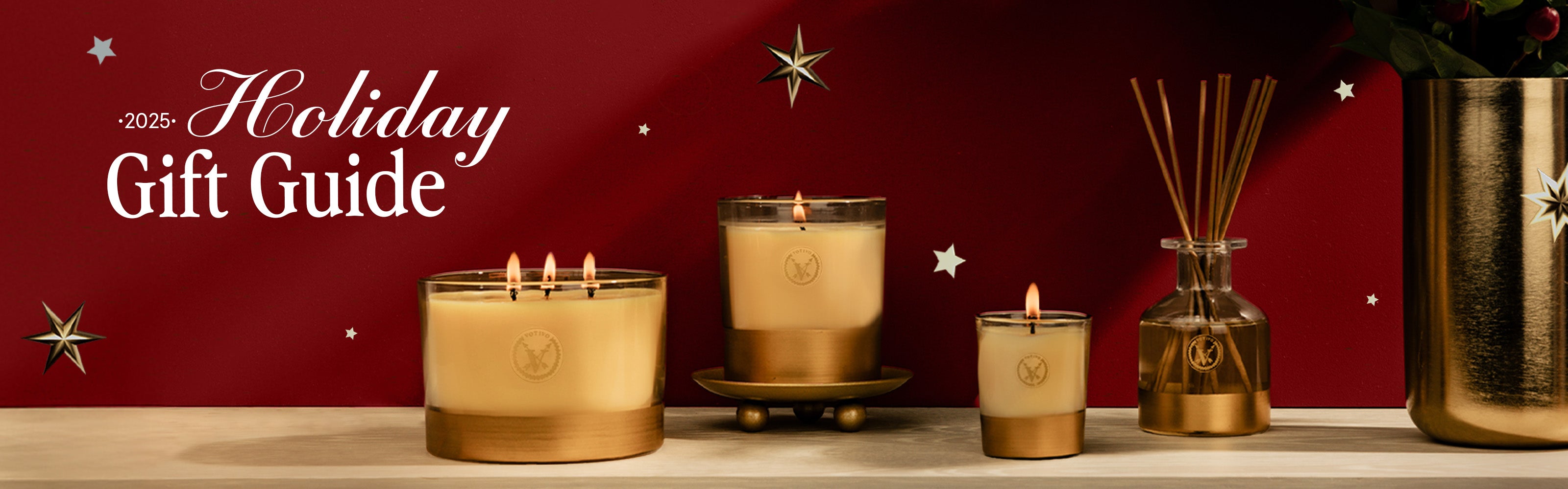Votivo 2025 holiday gift guide with holiday candles and reed diffuser on a red background