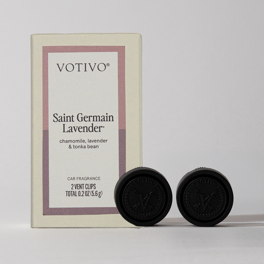 A box of Votivo Saint Germain Lavender Car Fragrance (2 Pack) stands upright with two black vent clips in front, featuring a floral scent blend of chamomile, lavender, and tonka bean.