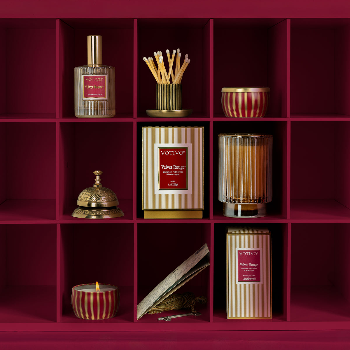 A velvet rouge collection image of candles and room sprays in burgundy cubbies