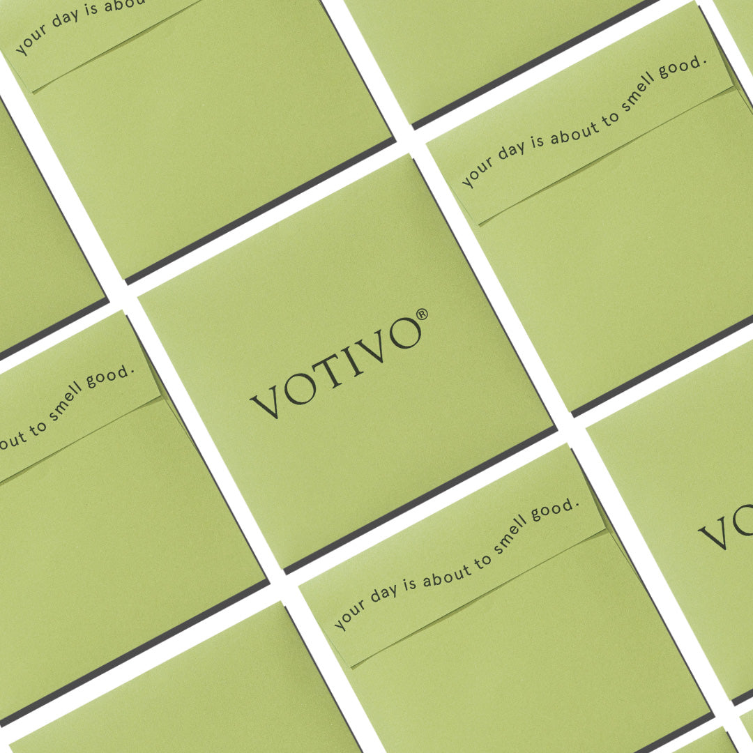 Several green square cards are arranged diagonally. The center card features Votivo Sample Kit by Votivo, while others say your day is about to smell good. Sold as a set of 1, total package weight: 0.1 pounds.