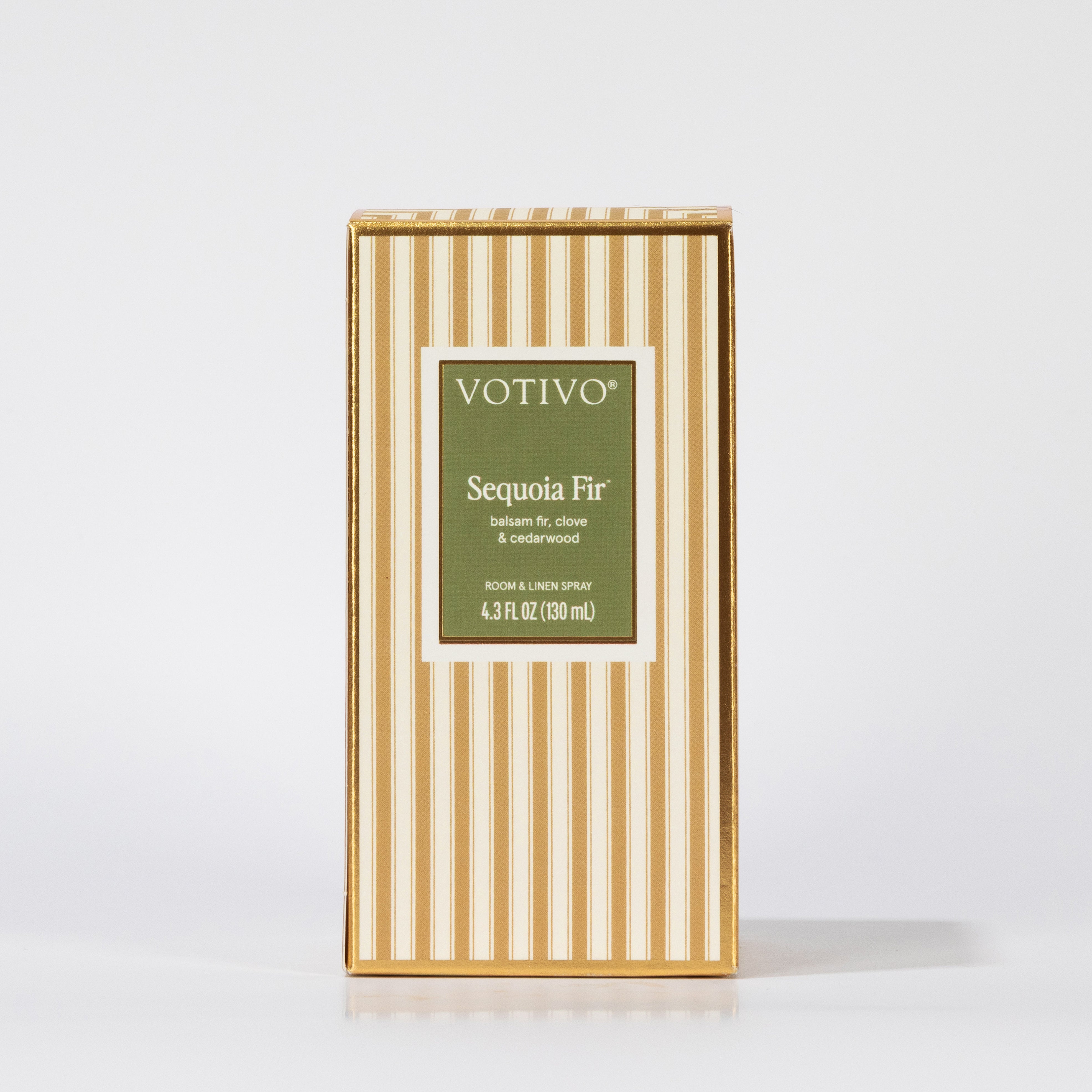 A rectangular box of Votivo Sequoia Fir Room & Linen Spray with gold and white stripes and a green front label, shown on a plain white background. Safe for fabric use.