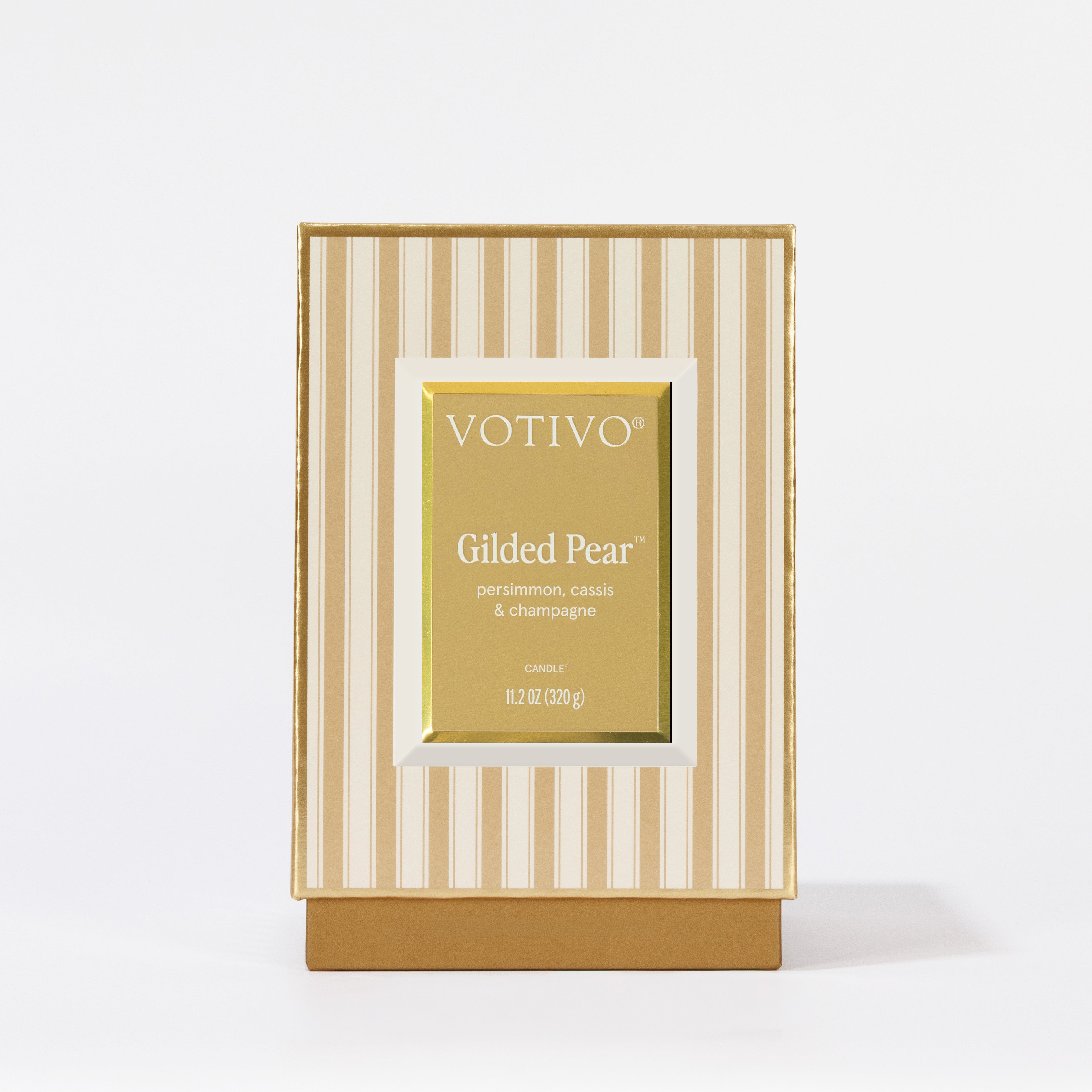 A gold and cream striped box, labeled Votivo Gilded Pear Holiday Candle—persimmon, cassis & champagne scent—11.2 oz (320 g), set against a white background.