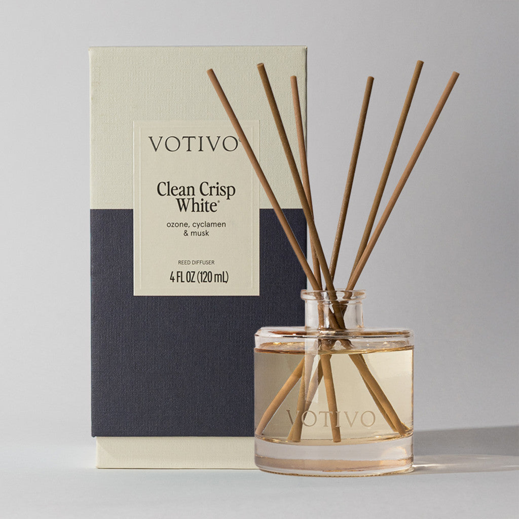 The Votivo Clean Crisp White Reed Diffuser fills your space with continuous scents of ozone, cyclamen, and musk. Light-colored liquid and slender reeds are housed in a sleek vessel and box for an elegant aromatic experience.