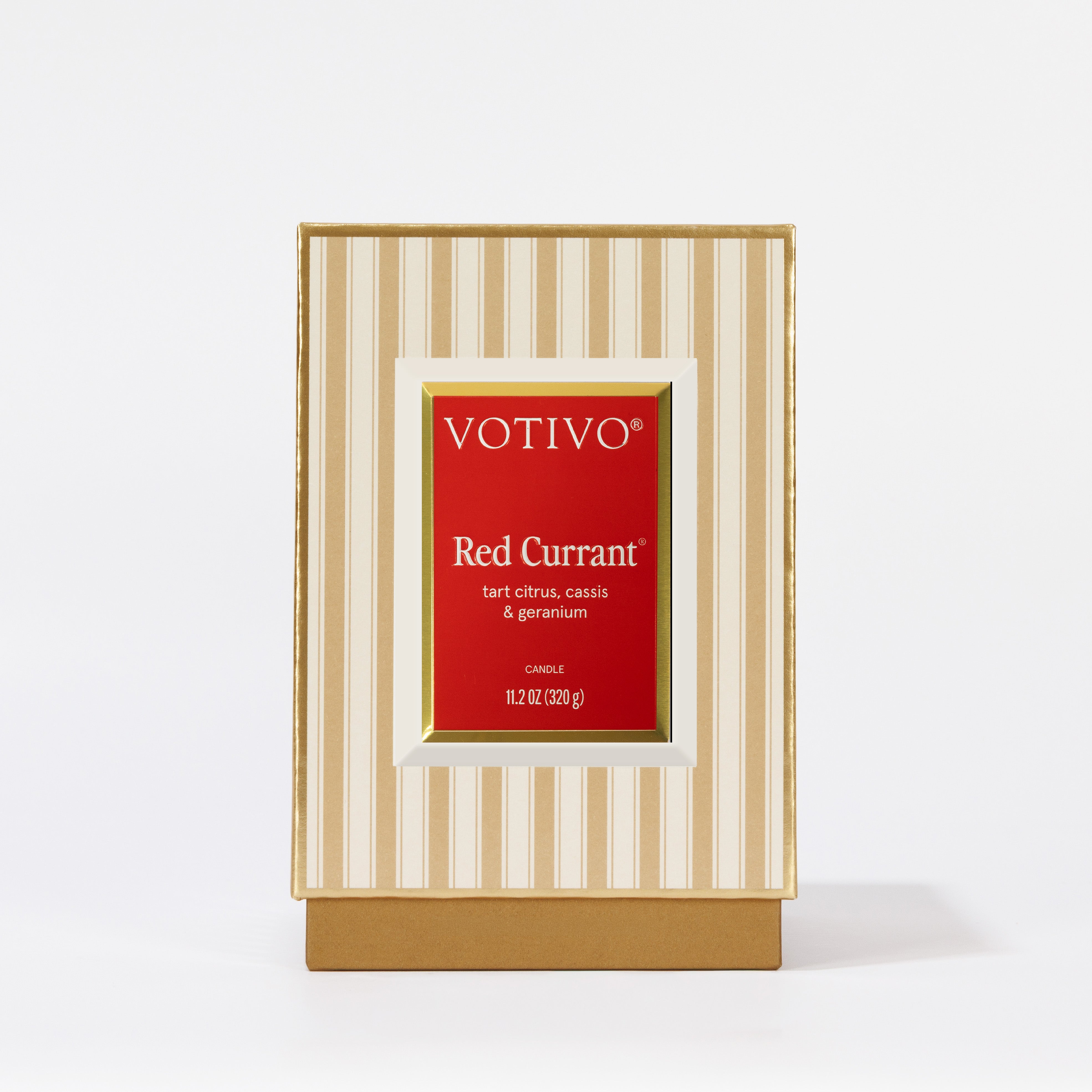 The Votivo Red Currant Holiday Candle comes in a beige and cream striped box with a red label noting tart citrus, cassis & geranium. This 11.2 oz soy blend candle is perfect for the holidays.