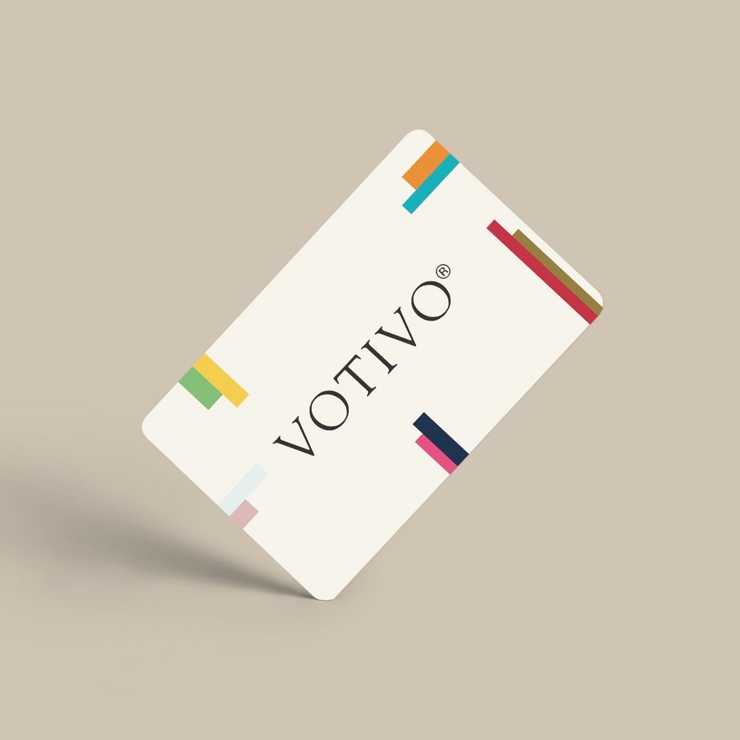 The Votivo E-Gift Card features a cream design with VOTIVO in black and colorful accents on a beige background—an ideal fragrance gift.