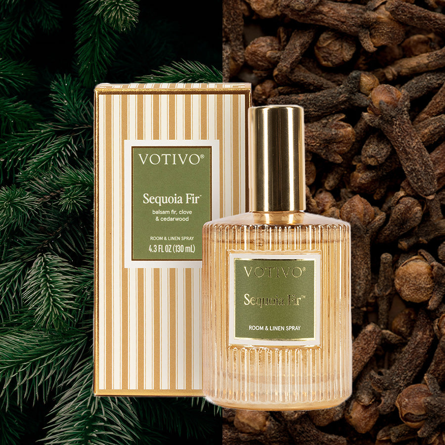 A bottle of Votivo Sequoia Fir Room & Linen Spray is shown with its striped box, fir branches, and cloves, emphasizing the festive, comforting scent. This fabric-safe spray infuses rooms and linens with the signature Sequoia Fir fragrance.