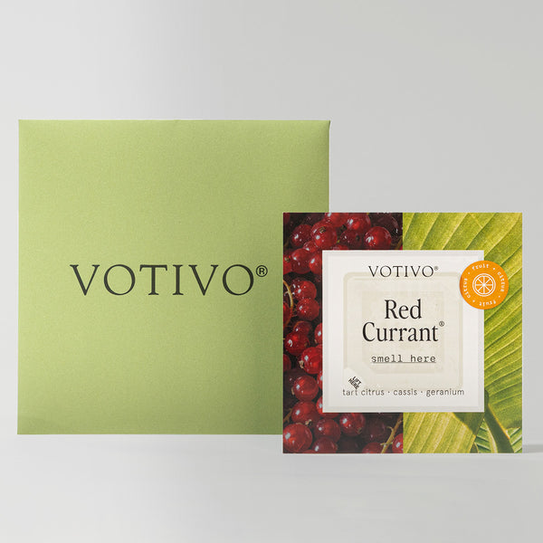 A green square Votivo box sits beside a Votivo Fragrance Sample Kit sachet labeled Red Currant, adorned with red currants and green leaves—perfect for discovering your signature scent of tart citrus, cassis, and geranium.