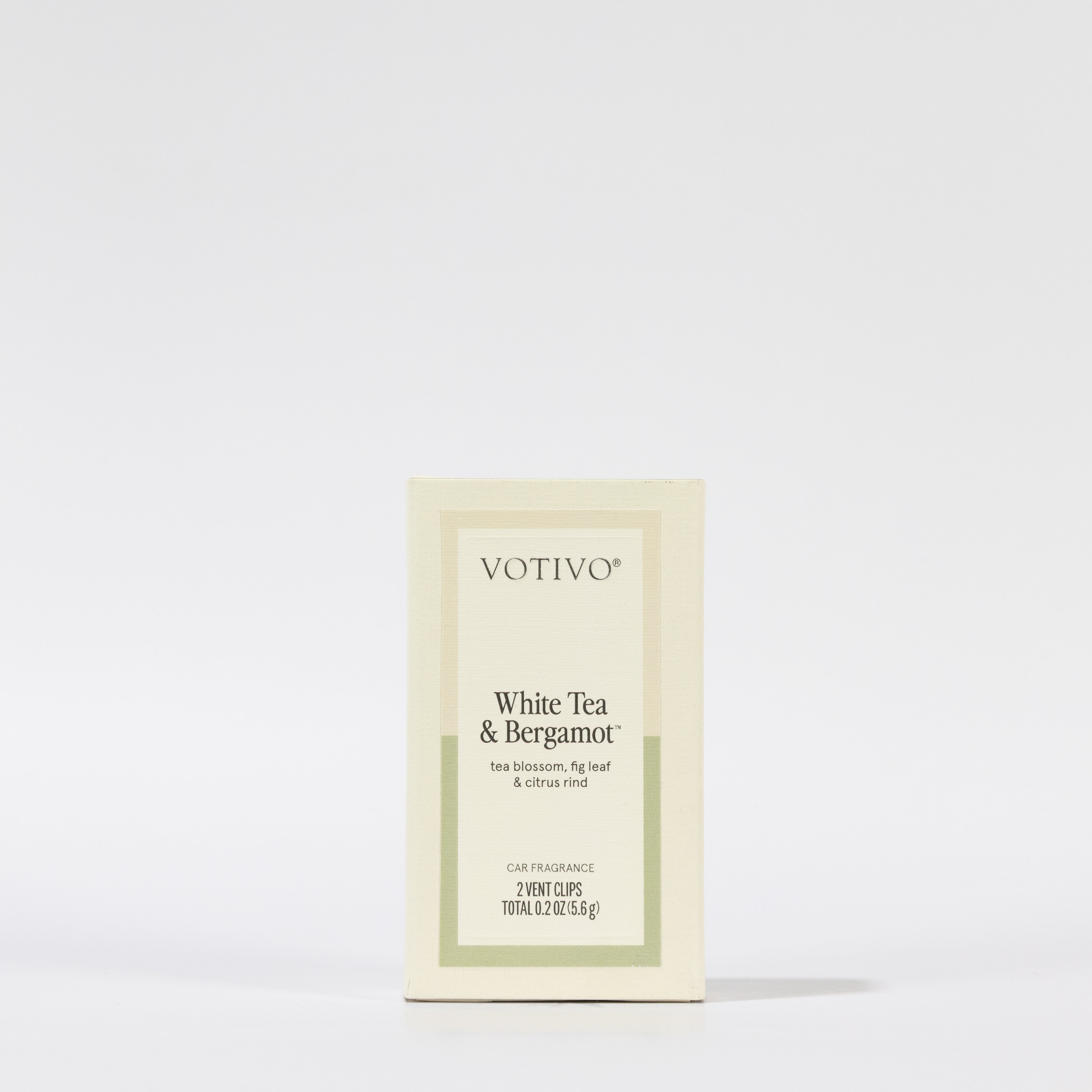 A Votivo White Tea & Bergamot Car Fragrance (2 Pack) box stands upright against a white background. The cream-colored, paraben-free packaging features minimal text and design, perfect for effortless scent on-the-go.
