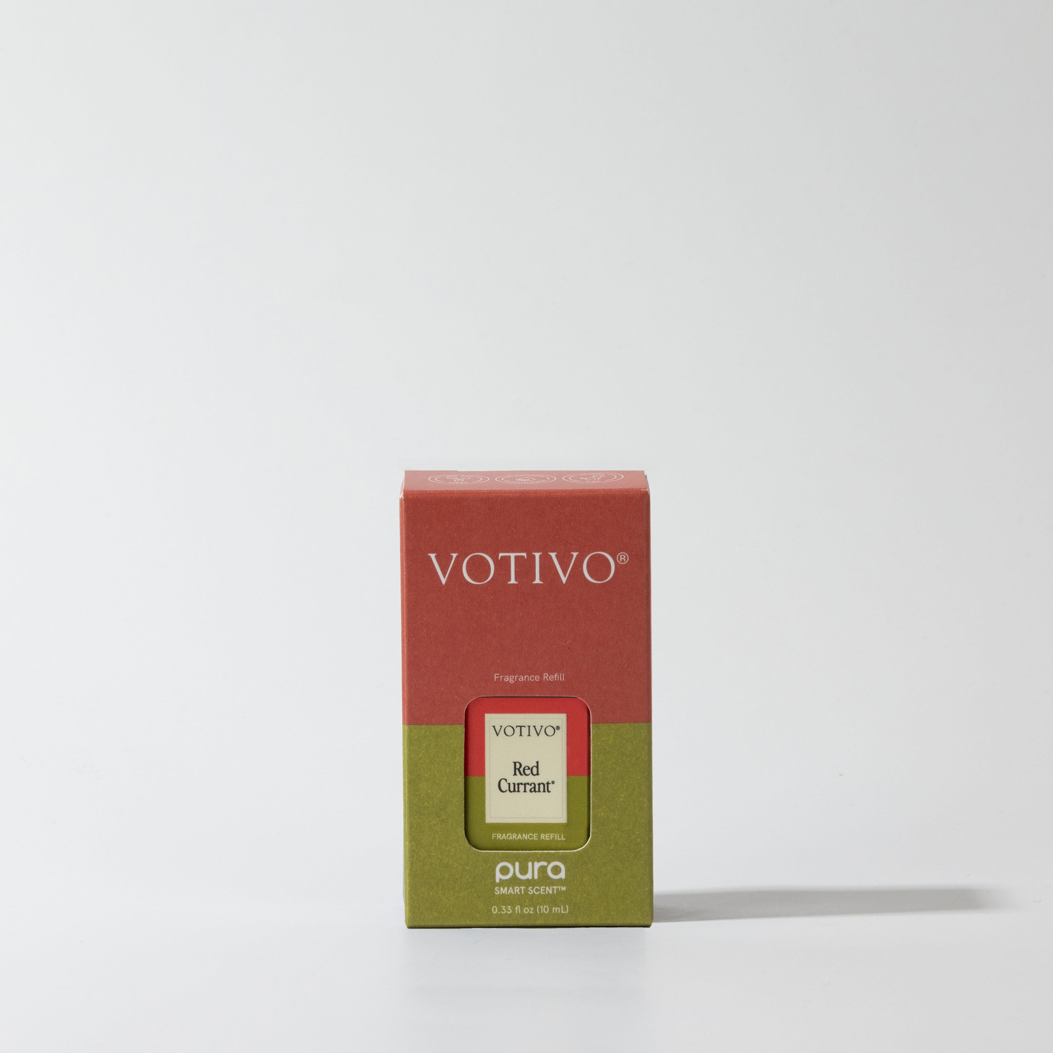 A Red Currant Votivo + Pura Fragrance Refill Vial by Votivo stands upright against a white background. Designed for the Pura Smart Diffuser, this box is red on top and green below, bringing an inviting Red Currant scent to your home.